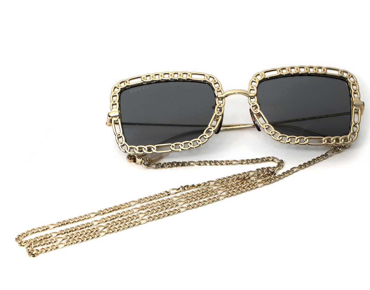 Gucci GG1112S-001-54 sunglasses in gold frame with grey lenses